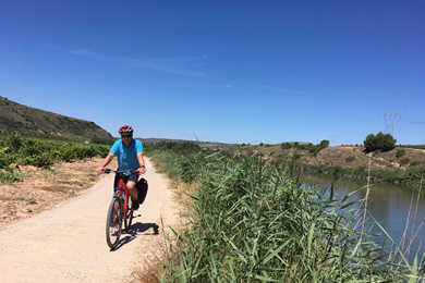 cyclist beside river Ebro
