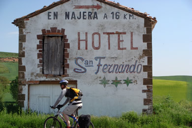 cyclist passing cool sign in La Rioja
